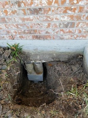 A Best Foundation Repair pier installation next to a home's foundation in Houston