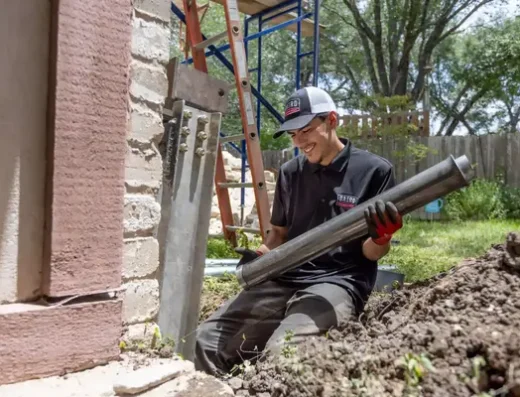Baird Foundation Repair foreman installing push pier pipes in Houston