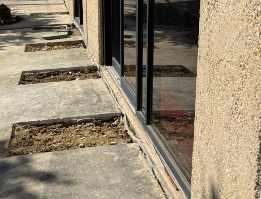 Sunken concrete porch slab pulling away from a Houston home's foundation, a common settlement issue Hercules Foundation Repair fixes
