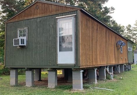 Elevated wooden house on concrete piers, the type of pier-and-beam foundation HTX Foundation Repair services in Houston