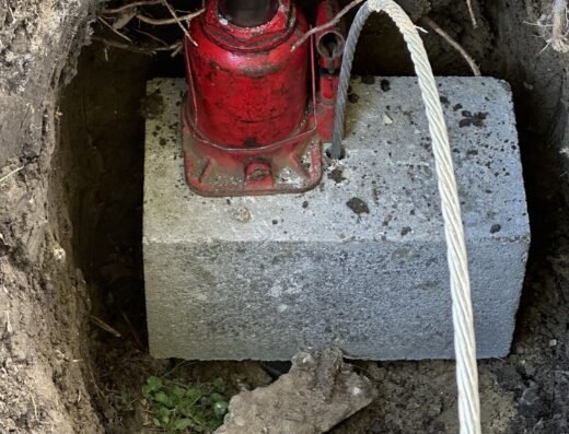 Concrete foundation pier with drainage pipe installed by Olshan Foundation Repair in Houston