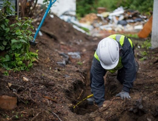 Perma Pier crew digging a trench to install a french drain for foundation maintenance in Houston