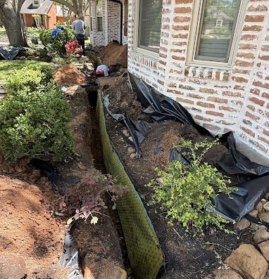 R.L. Nelson crew installing a root barrier to protect a home's foundation from tree root damage
