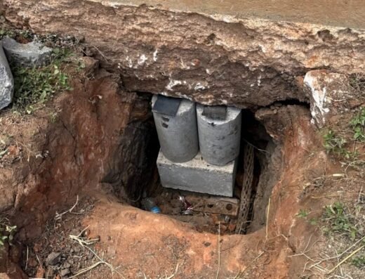 Pressed concrete pilings and a hydraulic jack in an access pit at a Houston slab edge