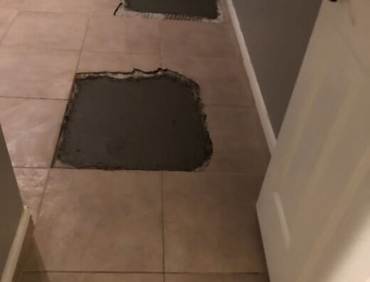Interior floor slab patches from an under-slab plumbing repair by Two Brothers Foundation Repair