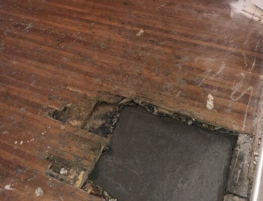 Exposed and patched concrete slab floor during a Two Brothers Foundation Repair job in Houston