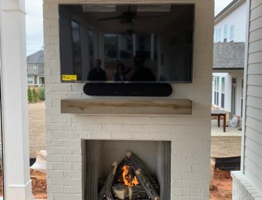 Mad Hatter completed outdoor brick fireplace with TV mount installation