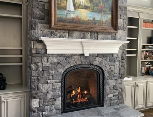 Mad Hatter completed stone fireplace installation with built-in shelving